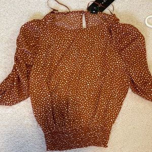 orange and white polka dot blouse